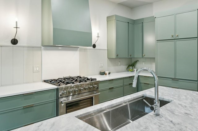 2760 Fraser St SE, Smyrna, GA 30080 - kitchen with green cabinets and stainless steel gas stove
