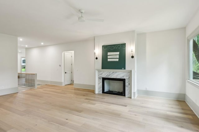 2760 Fraser St SE, Smyrna, GA 30080 - unfurnished living room with ceiling fan, light wood-style flooring, a premium fireplace, recessed lighting, and baseboards