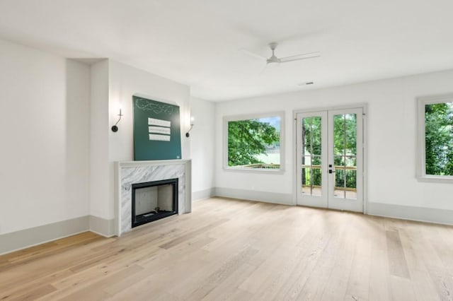 2760 Fraser St SE, Smyrna, GA 30080 - unfurnished living room featuring wood finished floors, a premium fireplace, a ceiling fan, baseboards, and french doors