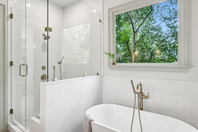 2760 Fraser St SE, Smyrna, GA 30080 - full bathroom with a shower stall, plenty of natural light, a freestanding tub, and tile walls