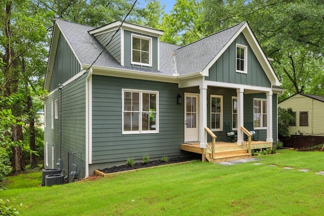 2760 Fraser St SE, Smyrna, GA 30080 - view of front of house featuring board and batten siding, a shingled roof, covered porch, a front lawn, and central air condition unit