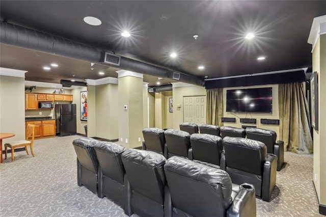 cinema room featuring light colored carpet and crown molding