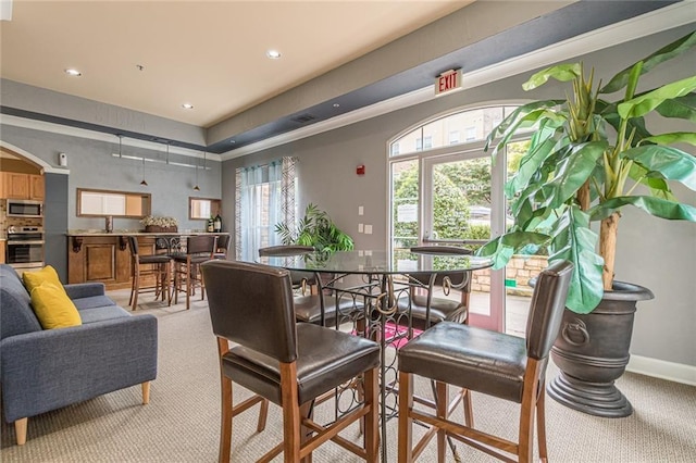 dining space featuring light colored carpet