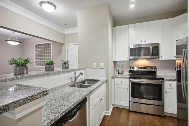 kitchen with white cabinets, appliances with stainless steel finishes, dark hardwood / wood-style floors, and sink