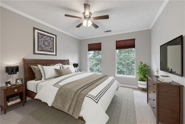 carpeted bedroom with ceiling fan, crown molding, and a textured ceiling