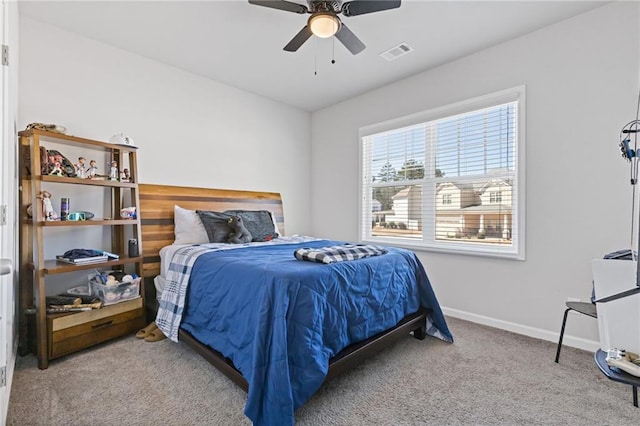 carpeted bedroom with baseboards, visible vents, and ceiling fan