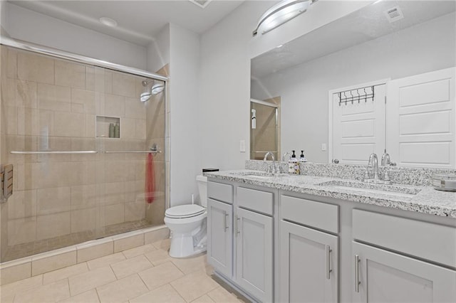 full bathroom featuring a sink, toilet, and a stall shower