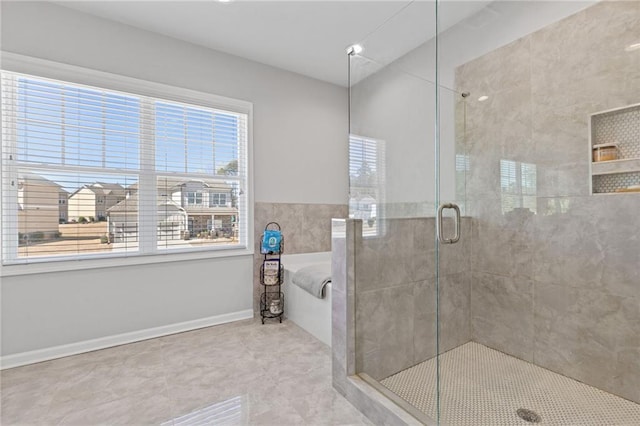 bathroom with tile patterned flooring, a shower stall, baseboards, and a garden tub