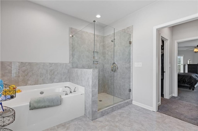 full bath featuring a stall shower, baseboards, and a bath