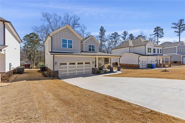 view of front facade featuring central air condition unit, driveway, board and batten siding, a front yard, and a garage