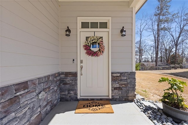 property entrance featuring stone siding