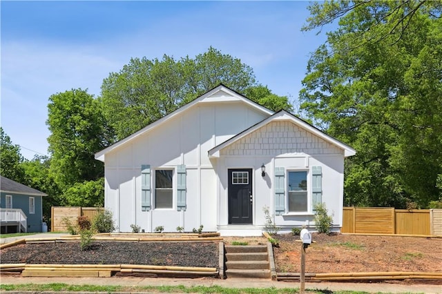 view of front of property featuring board and batten siding and fence