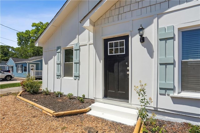 property entrance featuring board and batten siding