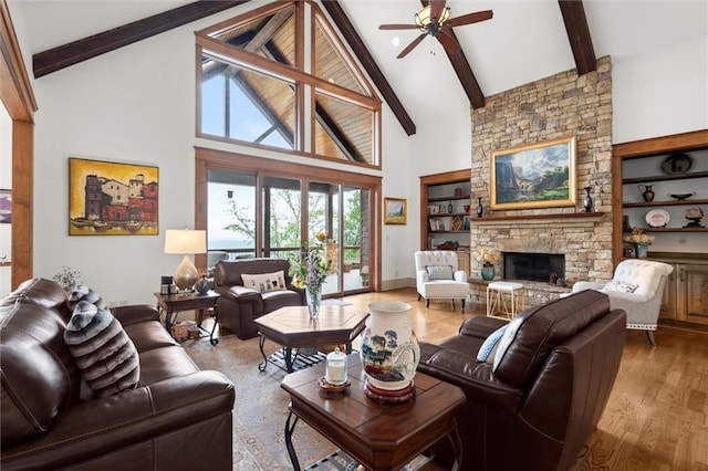 49 Waterside Dr SE, Cartersville, GA 30121 - living area featuring beam ceiling, a ceiling fan, high vaulted ceiling, a fireplace, and plenty of natural light