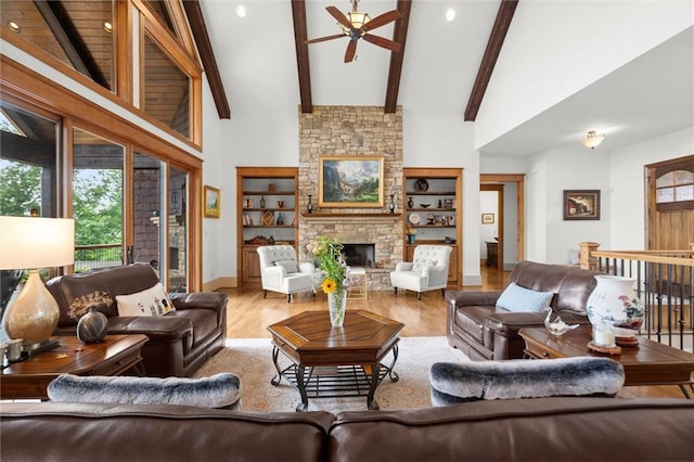 49 Waterside Dr SE, Cartersville, GA 30121 - living area featuring a ceiling fan, wood finished floors, a fireplace, beam ceiling, and high vaulted ceiling