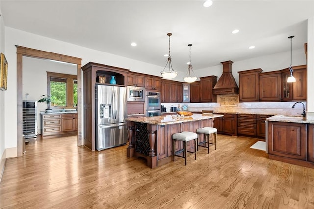 49 Waterside Dr SE, Cartersville, GA 30121 - kitchen featuring stainless steel appliances, a kitchen island, a breakfast bar area, light wood-style floors, and recessed lighting