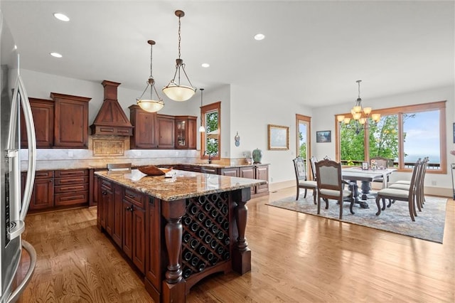 49 Waterside Dr SE, Cartersville, GA 30121 - kitchen with custom exhaust hood, light wood finished floors, freestanding refrigerator, decorative backsplash, and recessed lighting