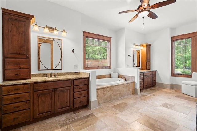49 Waterside Dr SE, Cartersville, GA 30121 - full bathroom with two vanities, stone tile floors, a garden tub, and a ceiling fan