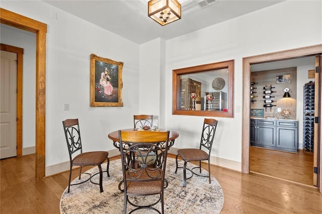 49 Waterside Dr SE, Cartersville, GA 30121 - dining area with light wood-type flooring and a bar