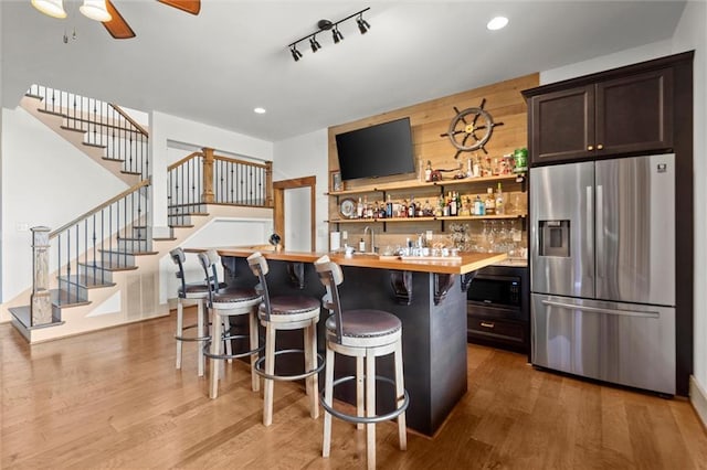 49 Waterside Dr SE, Cartersville, GA 30121 - indoor wet bar featuring stainless steel fridge with ice dispenser, black microwave, stairway, wood finished floors, and recessed lighting