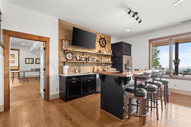 49 Waterside Dr SE, Cartersville, GA 30121 - indoor wet bar with stainless steel appliances, light wood-style floors, and recessed lighting