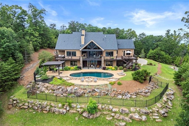 49 Waterside Dr SE, Cartersville, GA 30121 - rear view of property featuring a wooden deck, a patio, stairway, a chimney, and a pool with connected hot tub