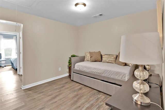 bedroom with hardwood / wood-style flooring