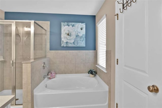 bathroom featuring separate shower and tub