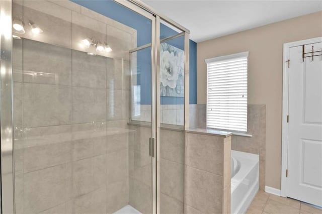 bathroom with shower with separate bathtub and tile patterned flooring