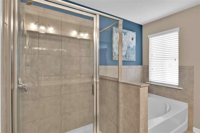 bathroom featuring plus walk in shower and a wealth of natural light