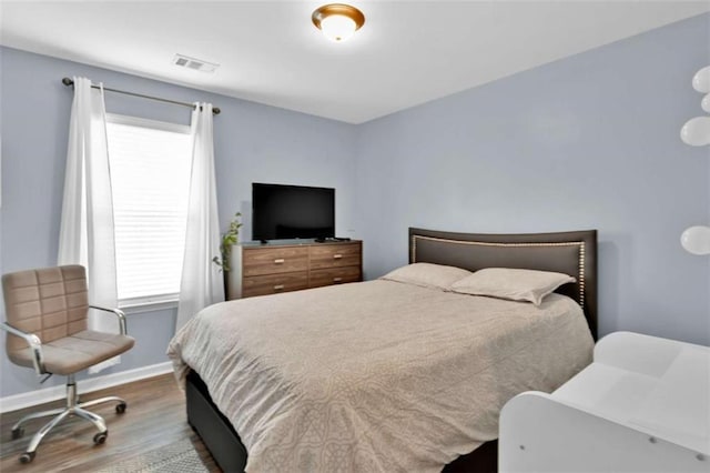 bedroom with hardwood / wood-style floors