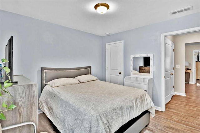 bedroom with light hardwood / wood-style floors