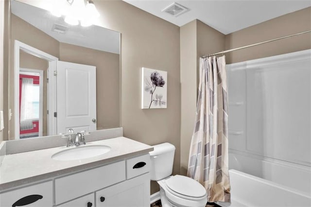 full bathroom with vanity, toilet, and shower / bath combo with shower curtain