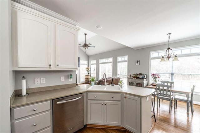 kitchen with ceiling fan, sink, stainless steel dishwasher, kitchen peninsula, and white cabinets