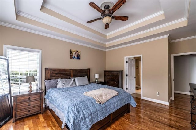 bedroom with a raised ceiling, ceiling fan, and crown molding