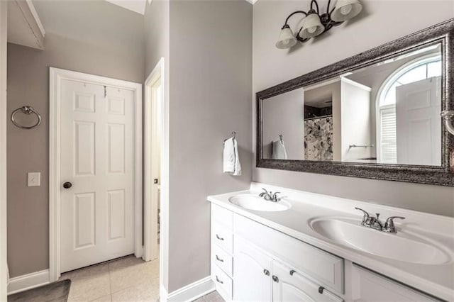 bathroom with curtained shower, tile patterned flooring, and vanity