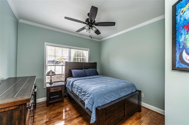 bedroom with ceiling fan, dark hardwood / wood-style floors, and crown molding