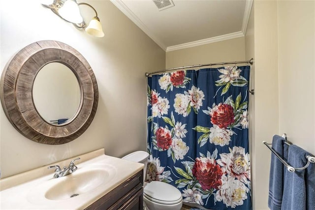 bathroom with vanity, toilet, ornamental molding, and walk in shower