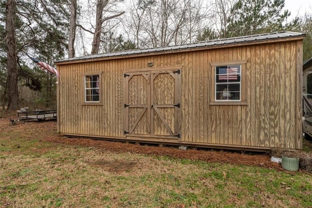 view of outbuilding with a lawn