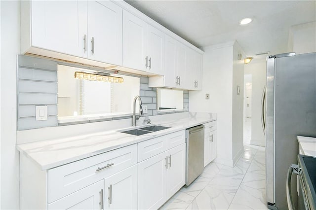 kitchen featuring white cabinetry, sink, light stone counters, and appliances with stainless steel finishes