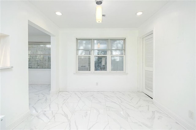 unfurnished room featuring crown molding