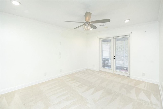 carpeted spare room with ornamental molding and ceiling fan