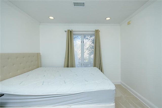 bedroom with light colored carpet and ornamental molding