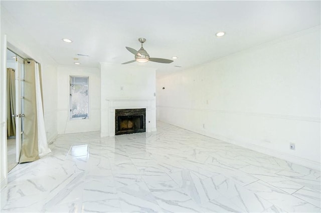 unfurnished living room featuring ceiling fan and a premium fireplace