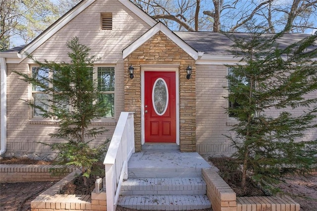 property entrance featuring stone siding and brick siding