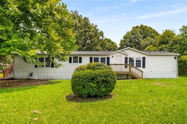 rear view of property with a yard and a deck