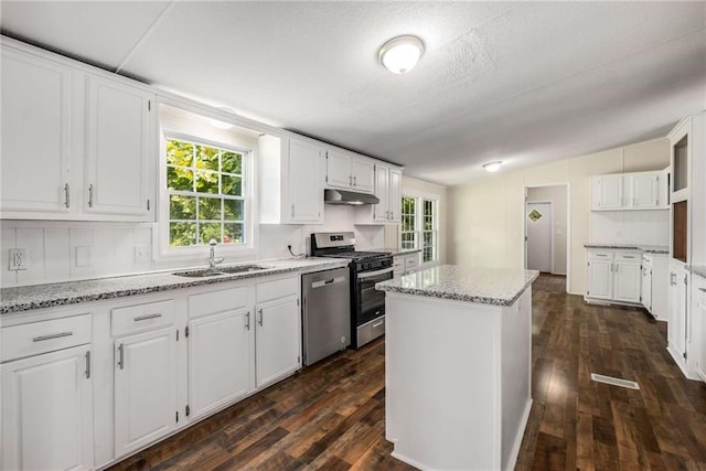 kitchen featuring white cabinetry, a center island, and stainless steel appliances