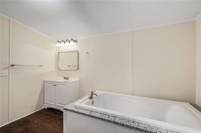 bathroom with vanity and a bath