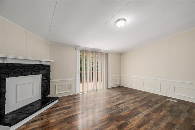 unfurnished living room featuring a stone fireplace and dark wood-type flooring