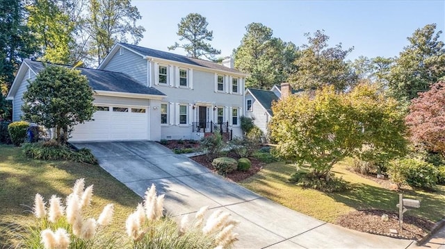 view of front of house with a front yard and a garage